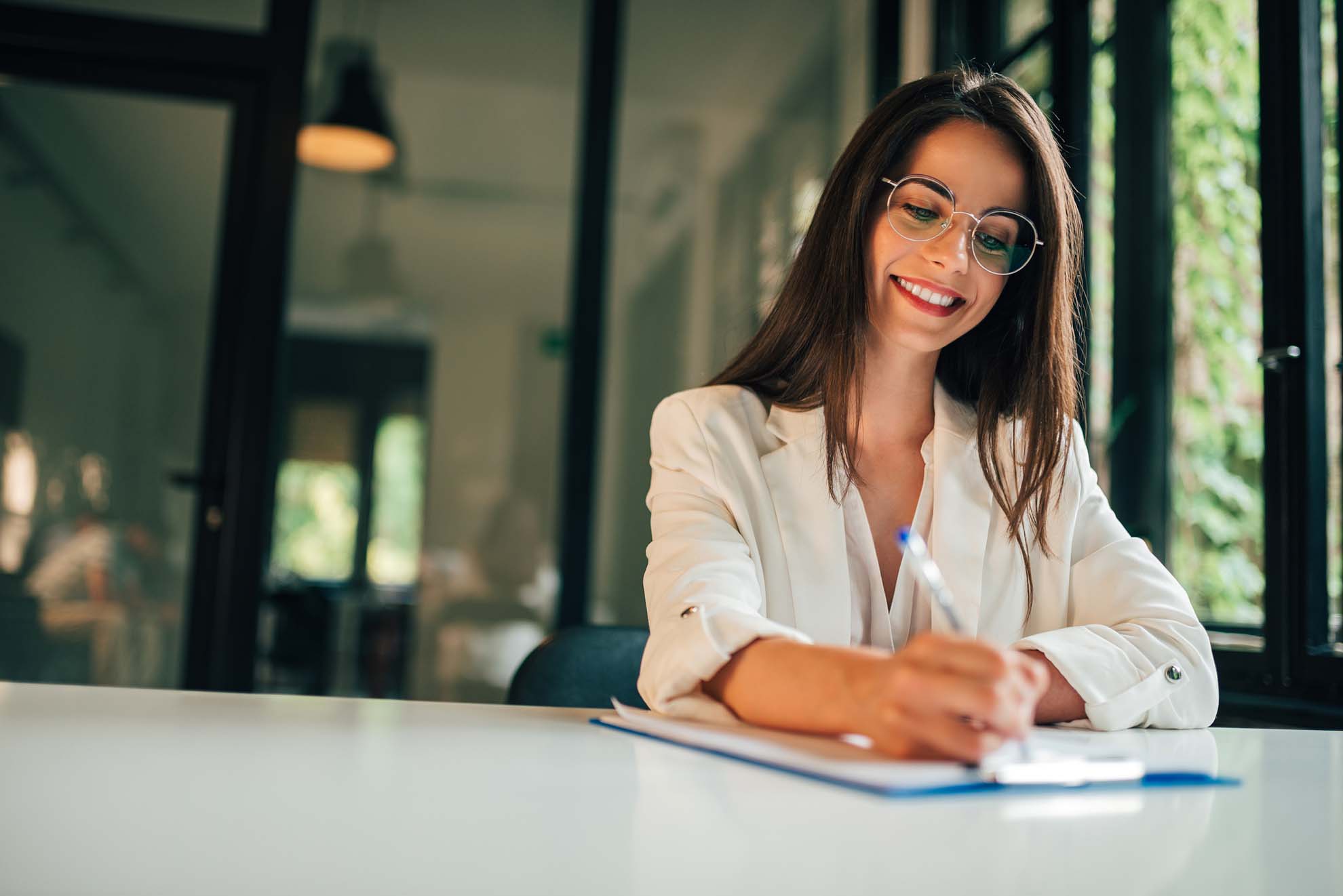 Motivated young woman hand filling application form.