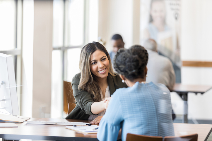 When the loan is processed, bank manager shakes customer’s hand